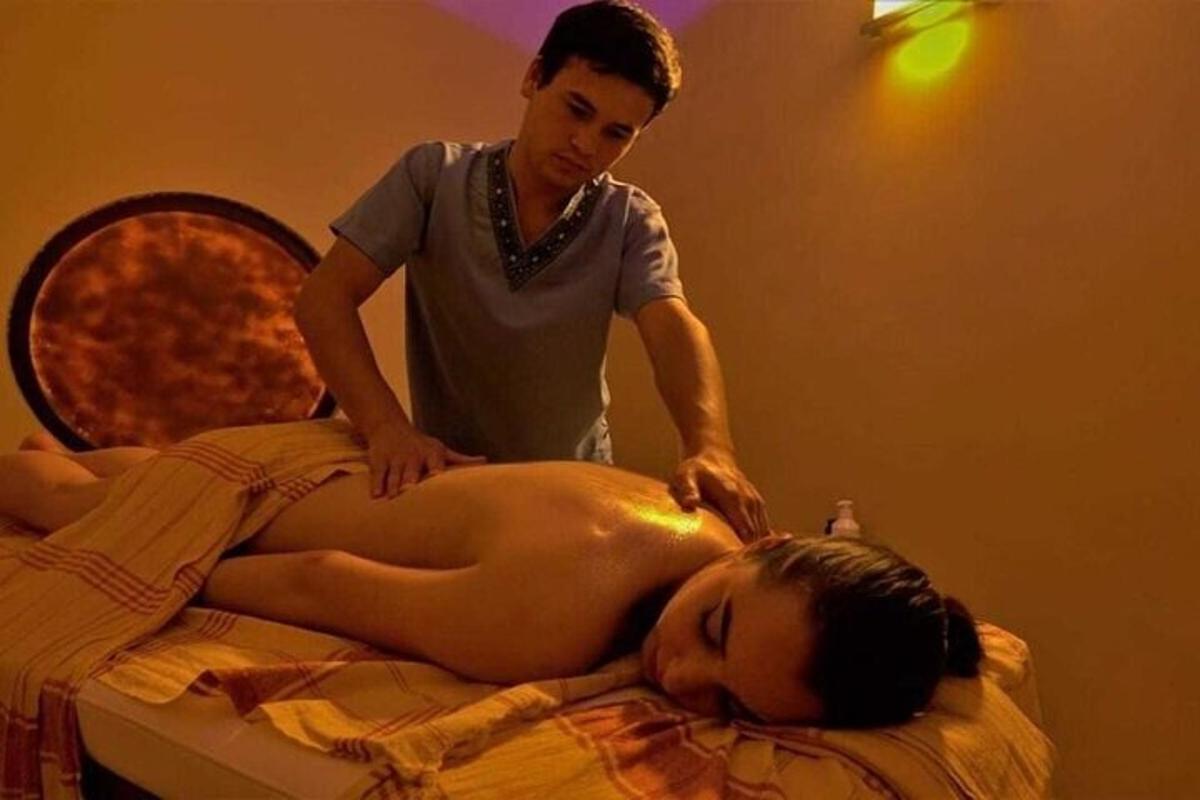 a man giving a woman a massage on a bed