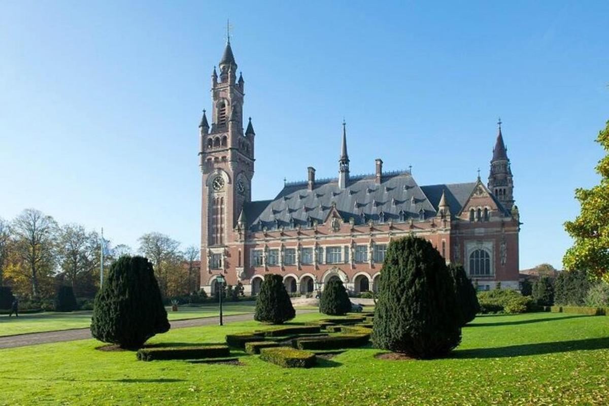 a large building with a clock tower in a park
