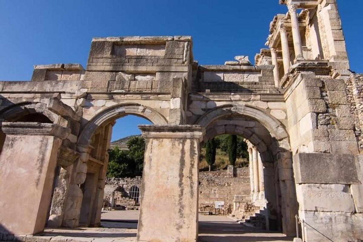 ancient archways in a building with a blue sky