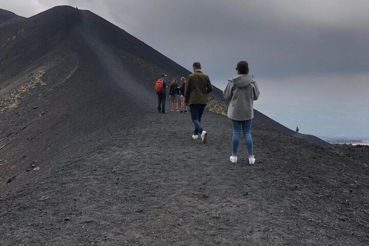 a group of people walking up a mountain