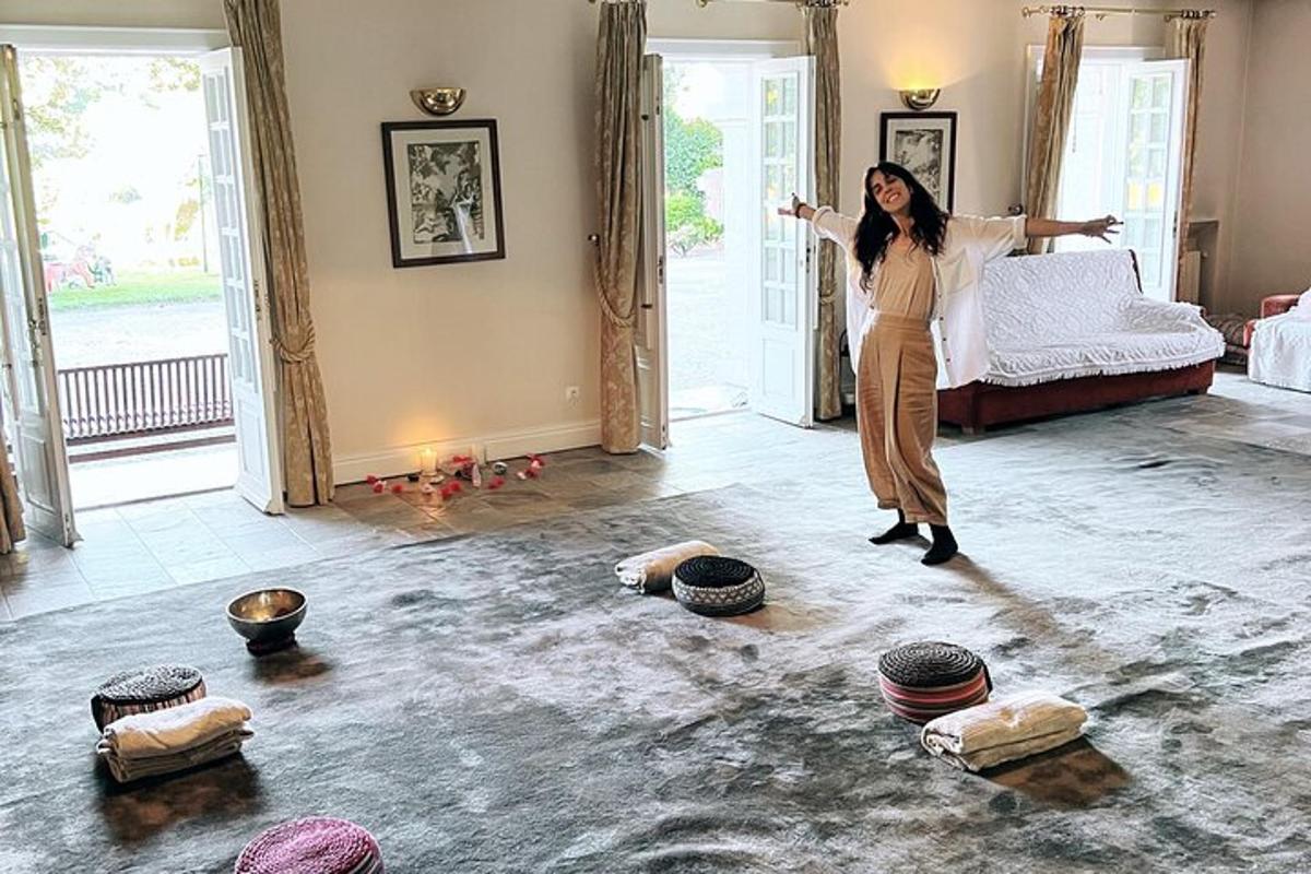 a woman standing in front of a bed in a room