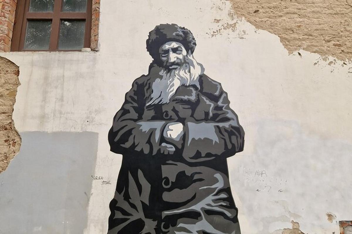 a statue of a man painted on the side of a wall