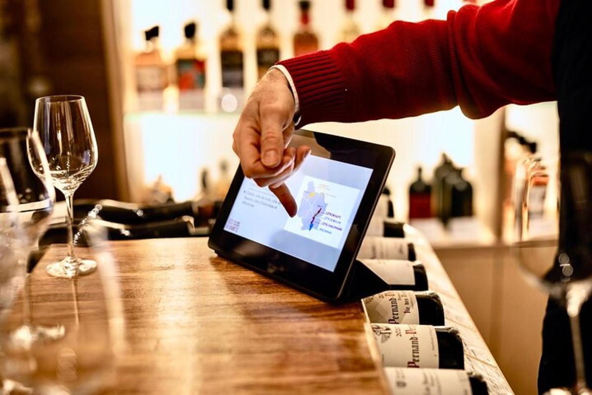 a person is pointing at a laptop on a table