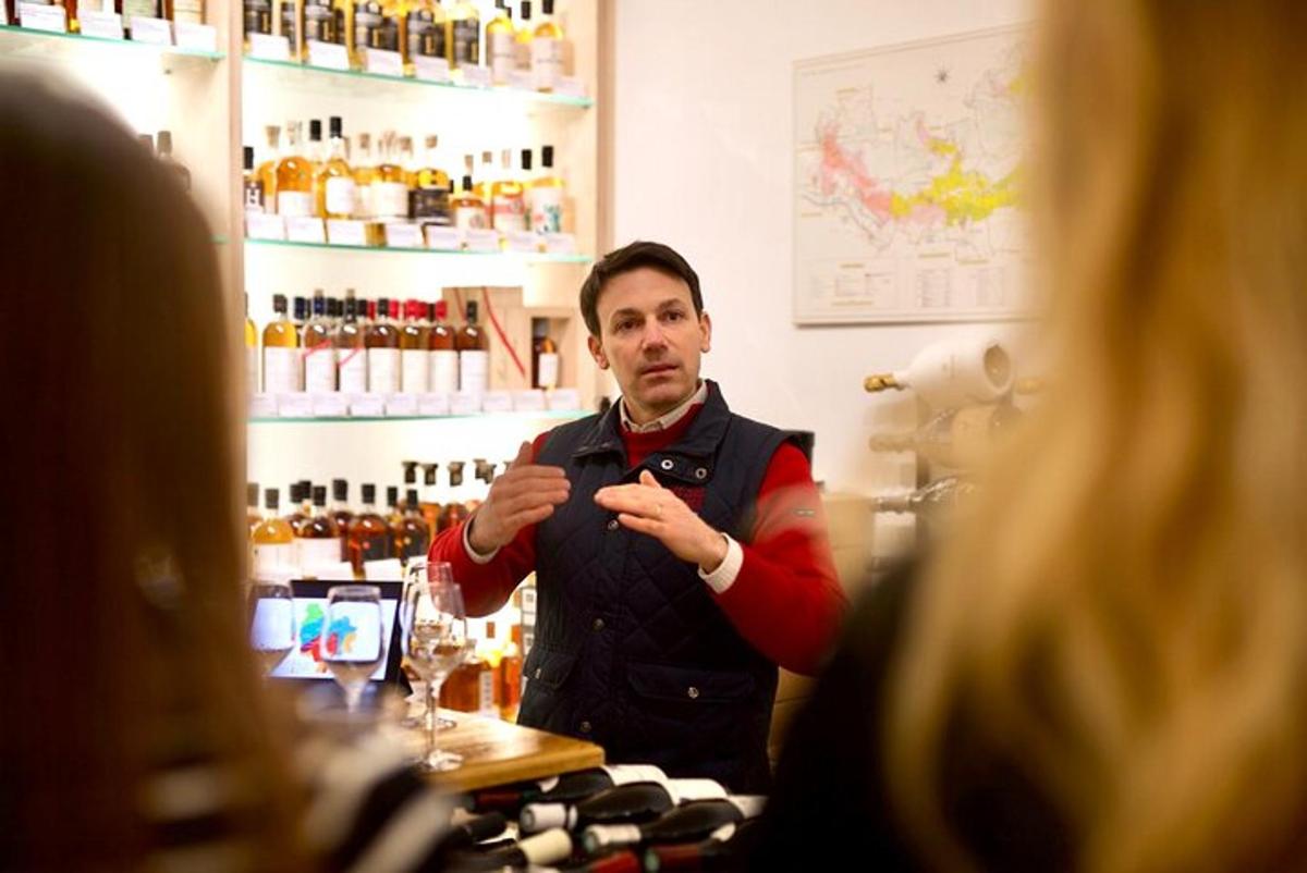 a man standing behind a bar in front of a mirror