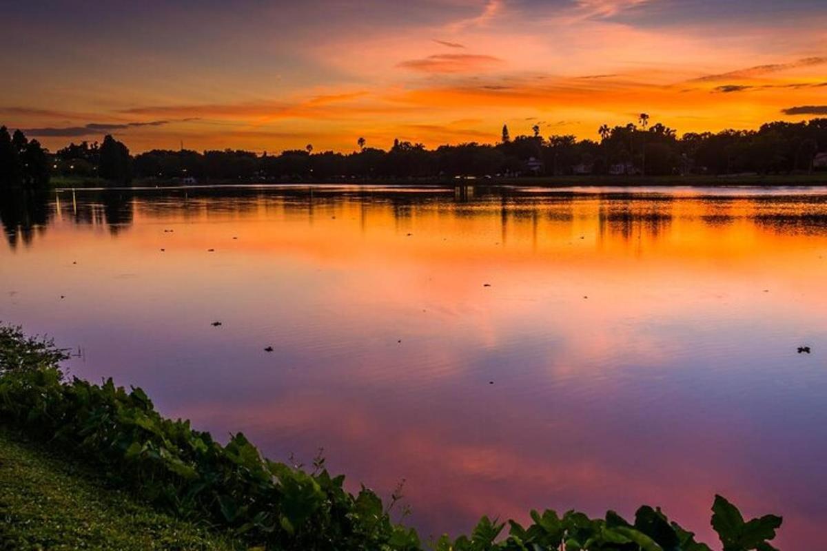 a large body of water with a sunset in the background