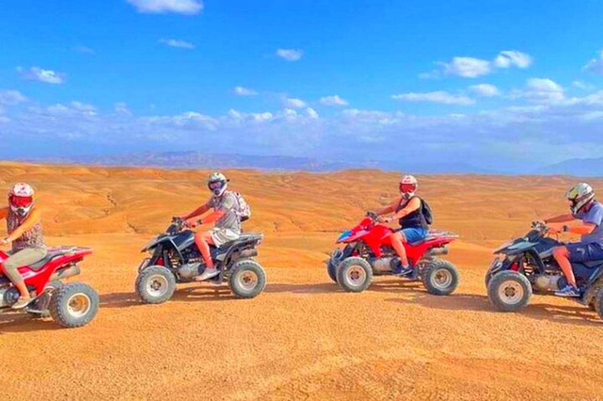 a group of people riding on atvs in the desert