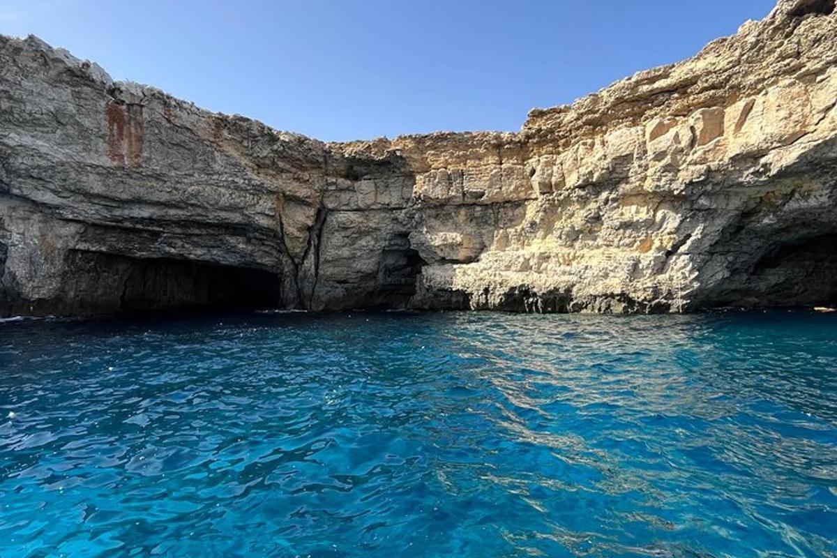 a large pool of water next to a cliff