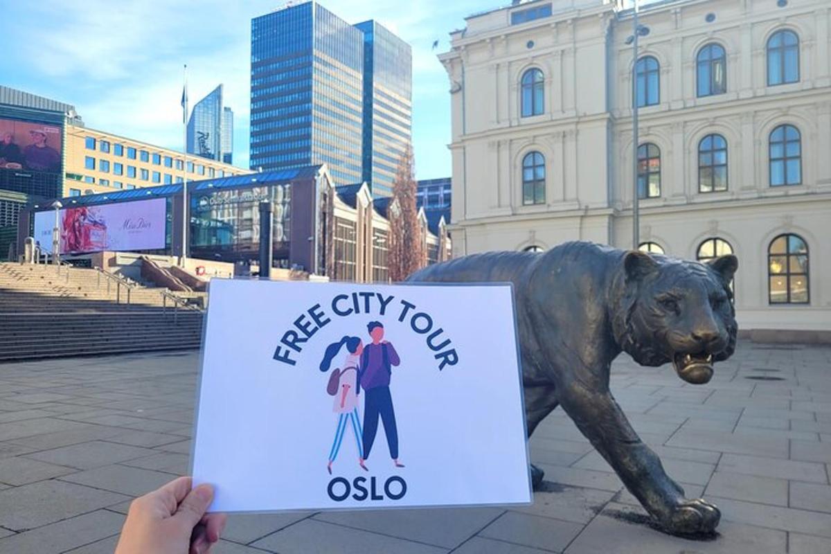 a person holding a sign in front of a statue