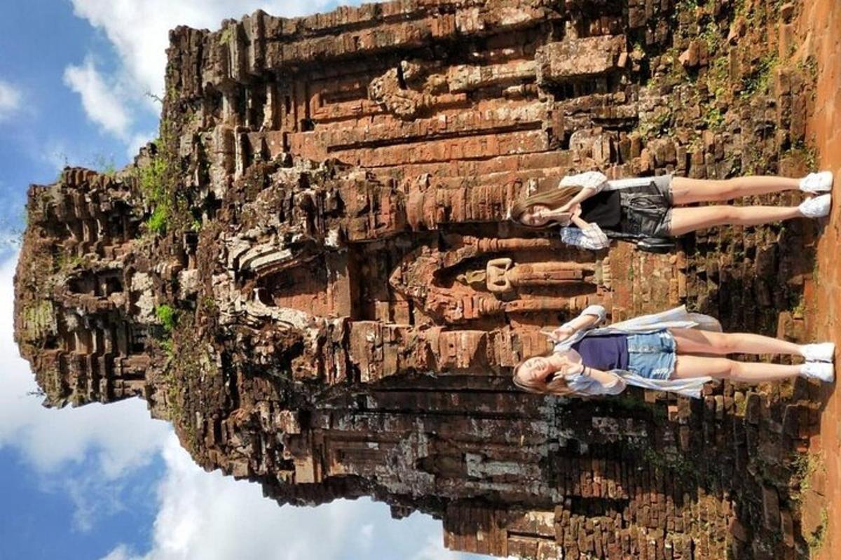two people laying on the side of a rock cliff
