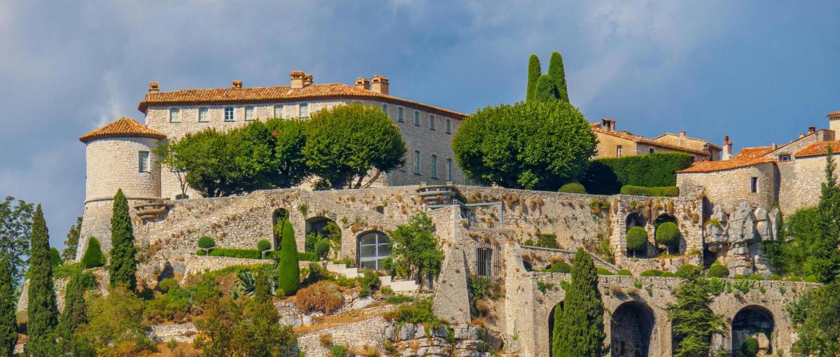 a castle on top of a hill with trees