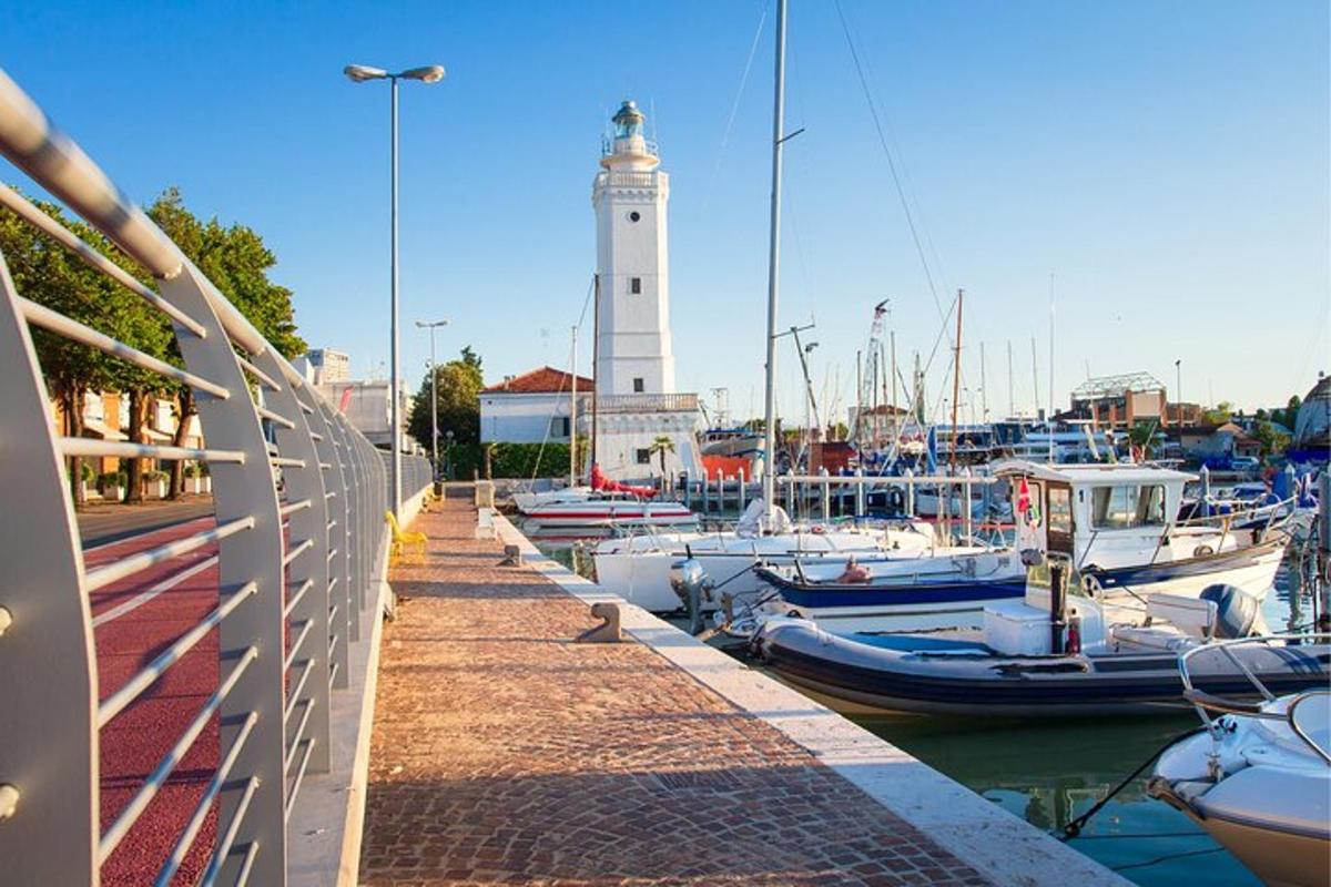 a group of boats docked in a marina with a lighthouse