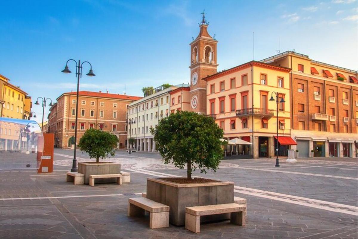 a city square with two benches and a clock tower