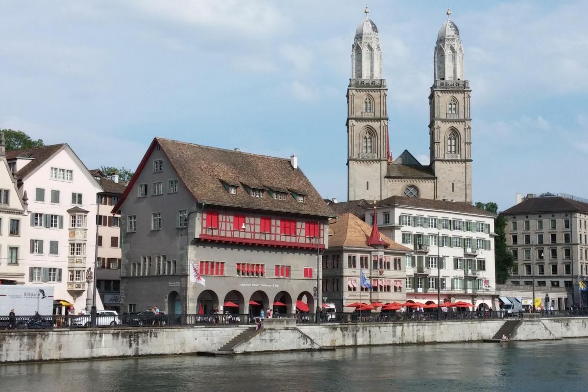 a group of buildings next to a river with two towers