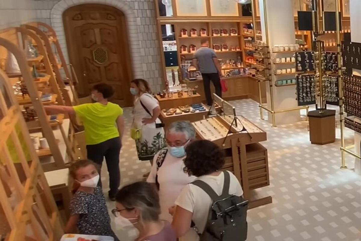 a group of people in a store wearing face masks
