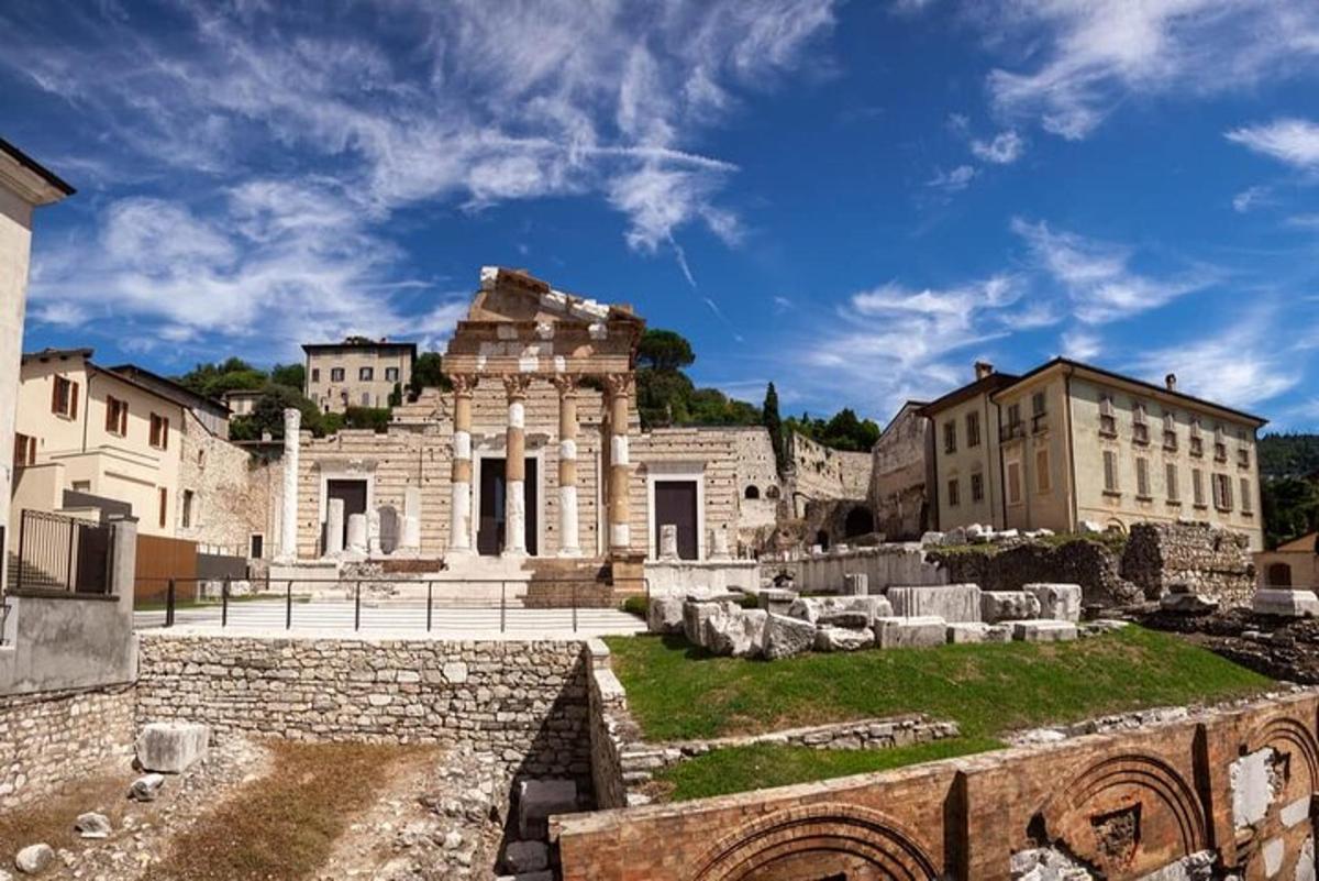 an ancient building in a city with a blue sky
