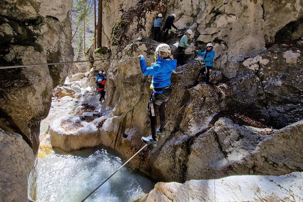 a group of people on a rope over a river