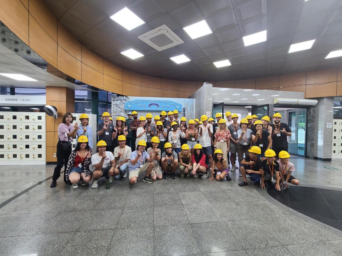a group of people wearing yellow helmets in a building