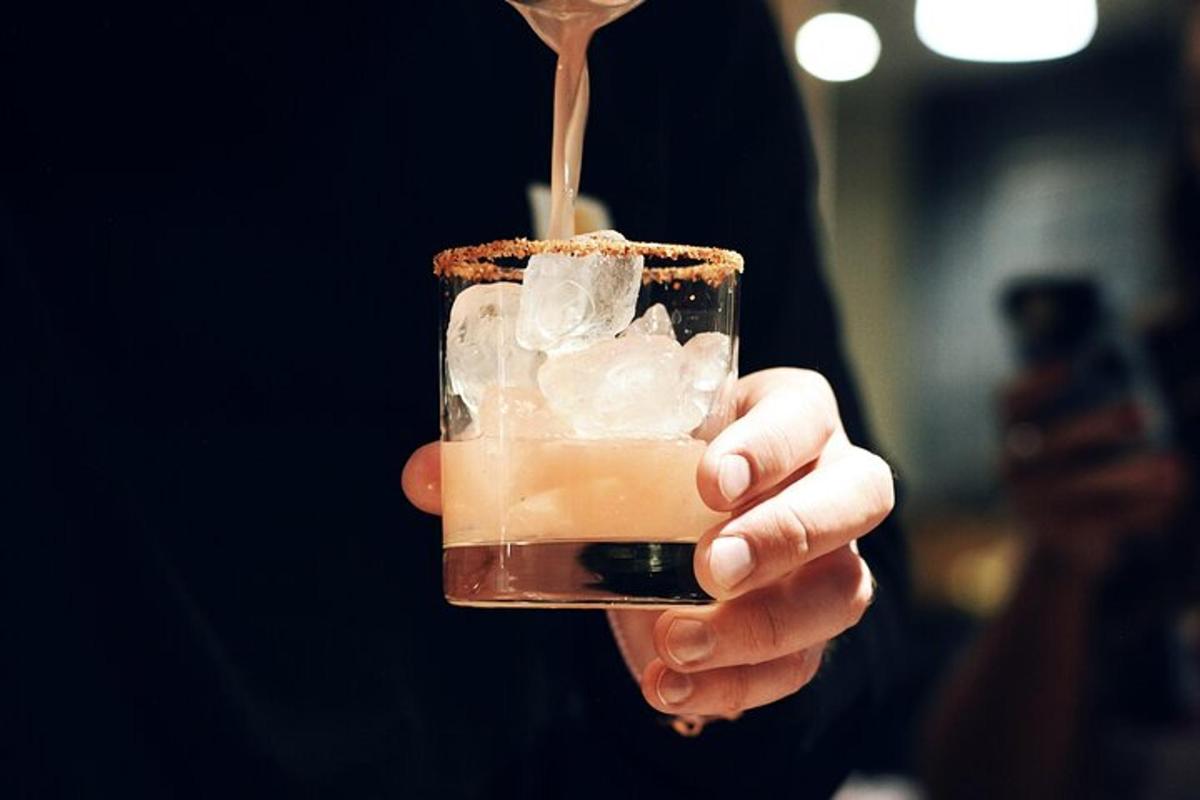 a person is holding a drink with a spoon