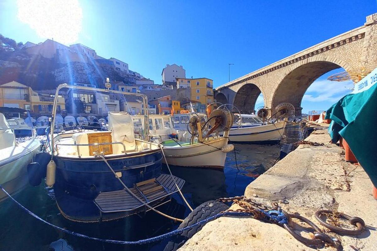 a group of boats in the water near a bridge