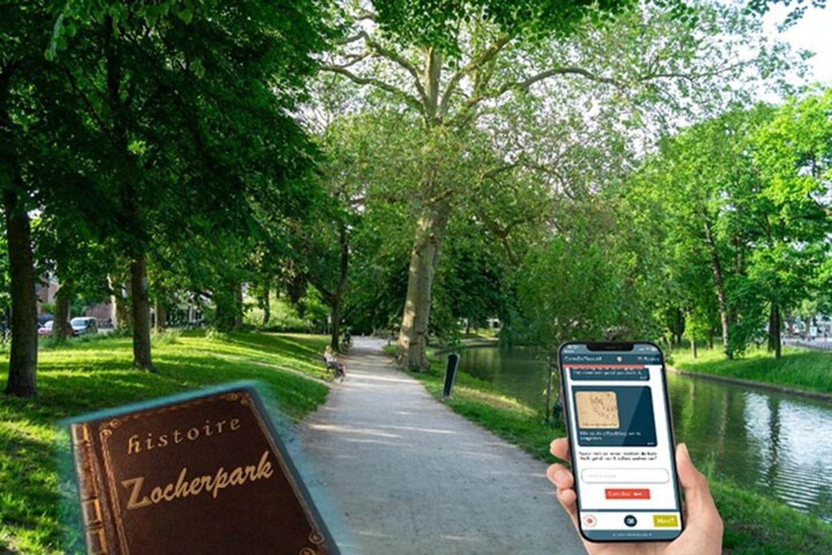 a person holding a cell phone in front of a park