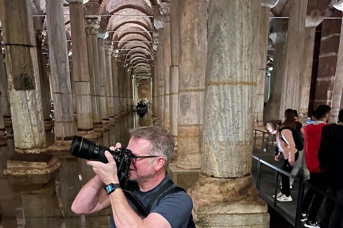 Un hombre con una cámara tomando una fotografía de un edificio.