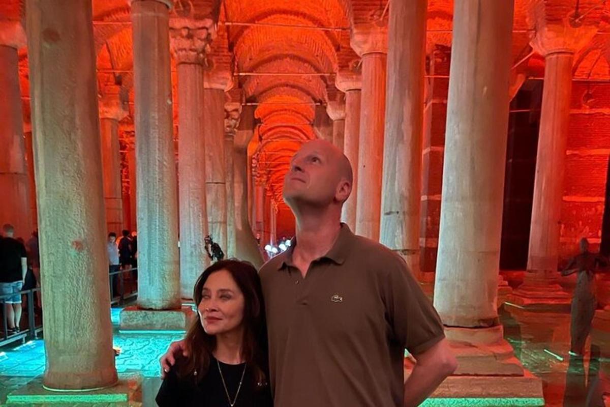 Un hombre y una mujer de pie en un edificio con columnas.
