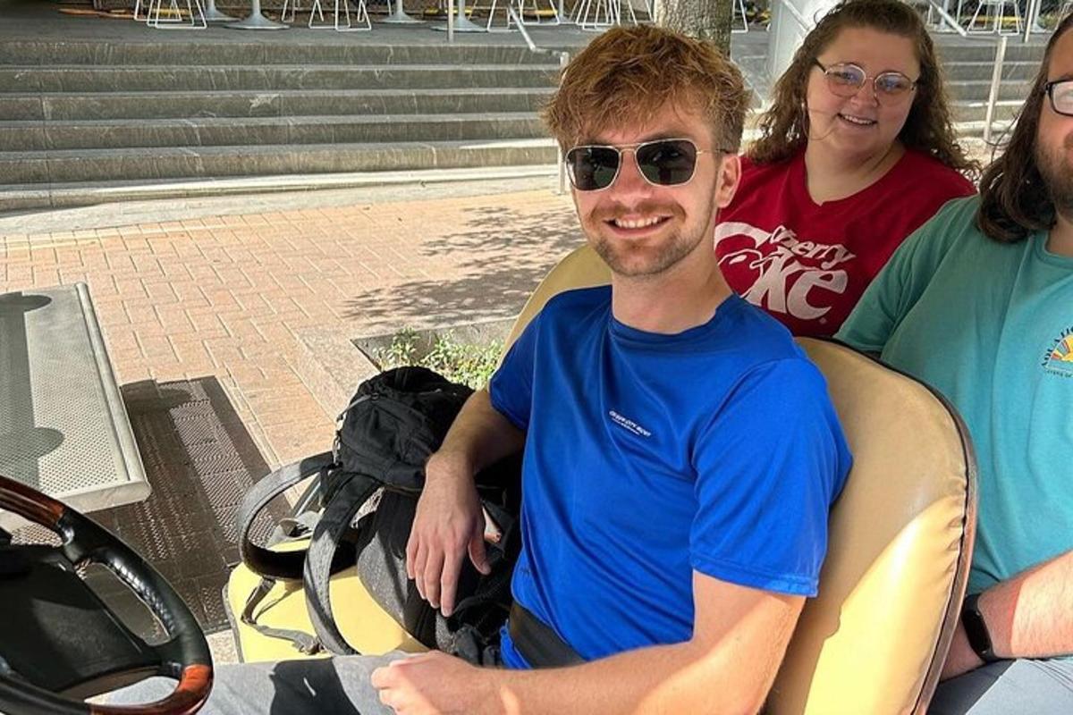 a man sitting in a chair with two women