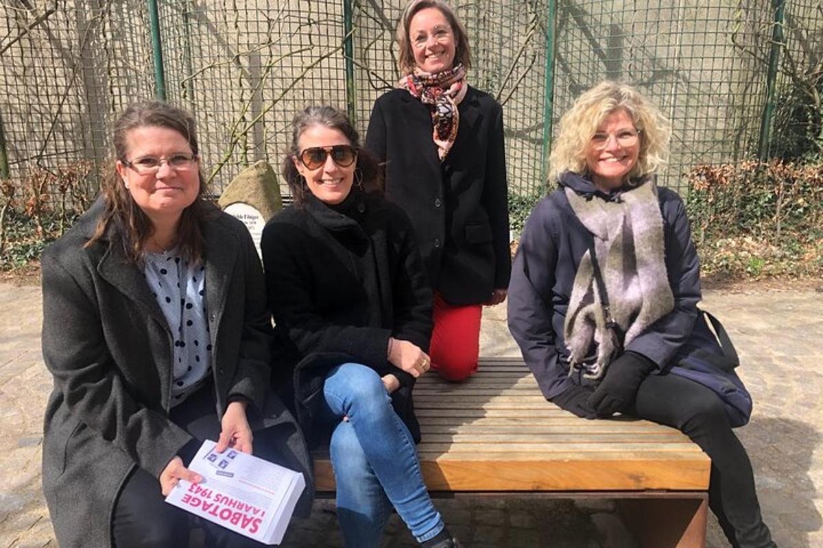 a group of three women sitting on a bench
