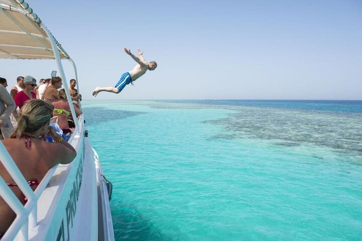 a person jumping off of a boat in the ocean