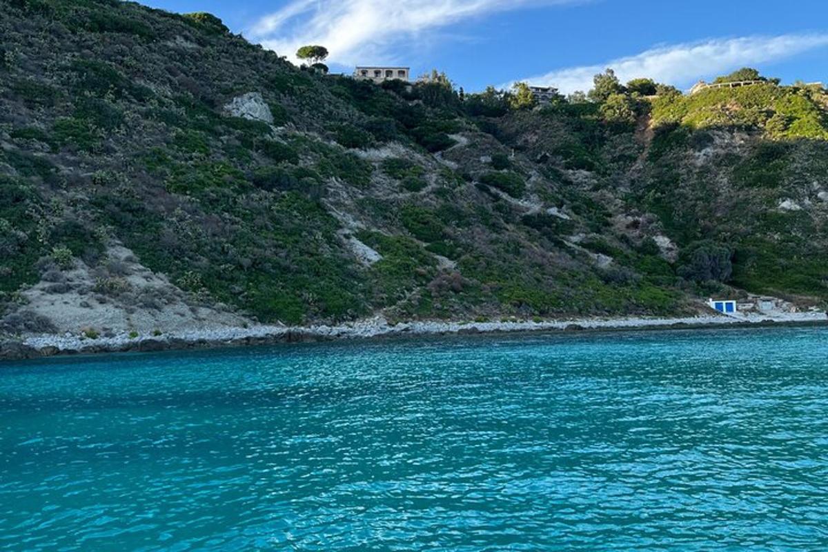 a large body of water next to a mountain