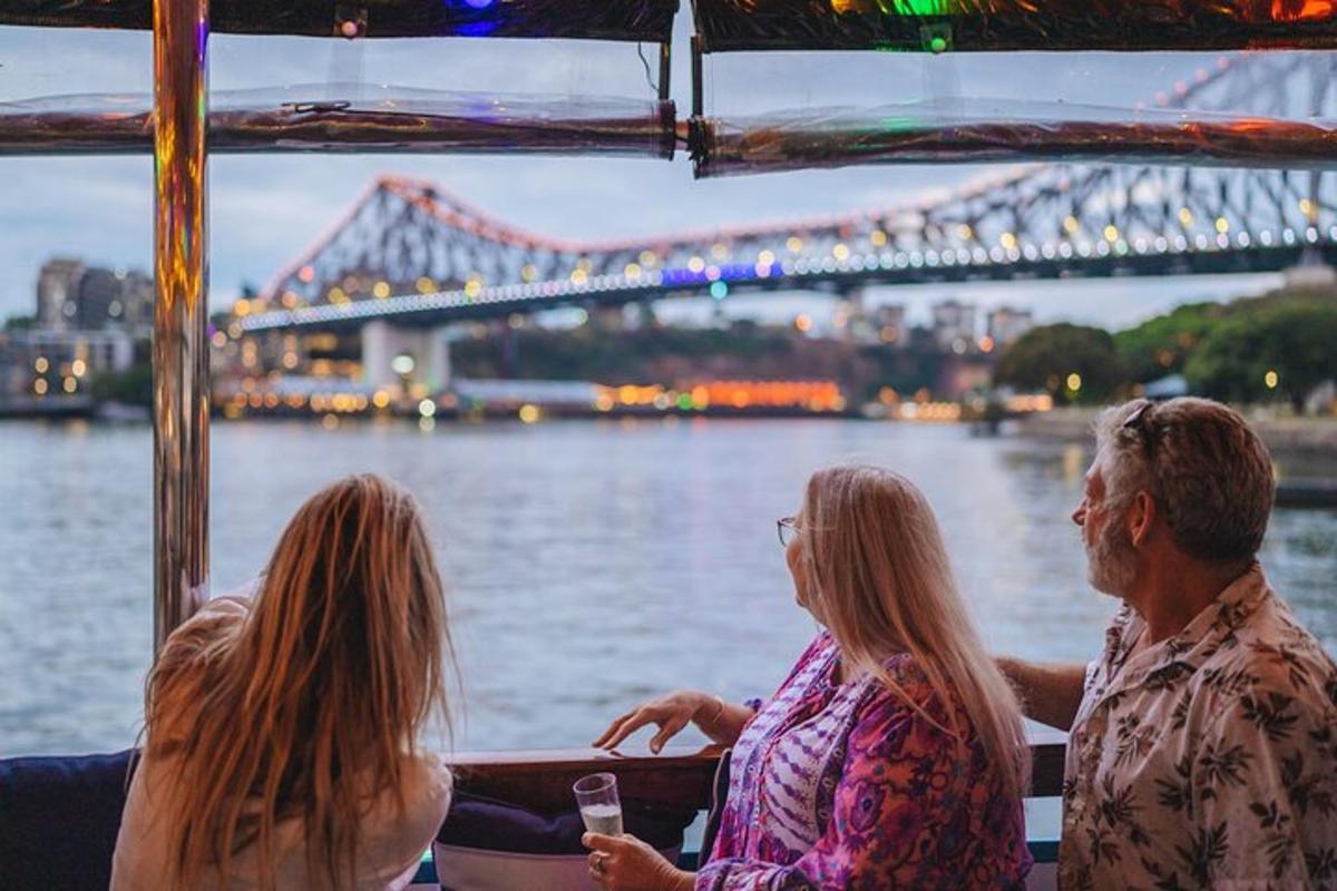 three people sitting on a boat with a bridge in the background