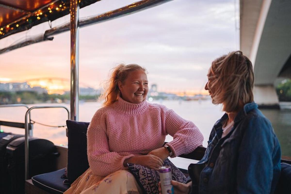 two women sitting on a boat on the water