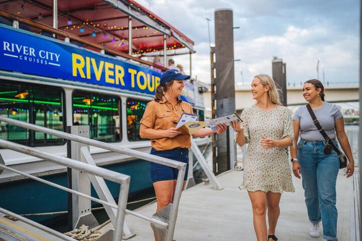 a group of three women standing next to a boat