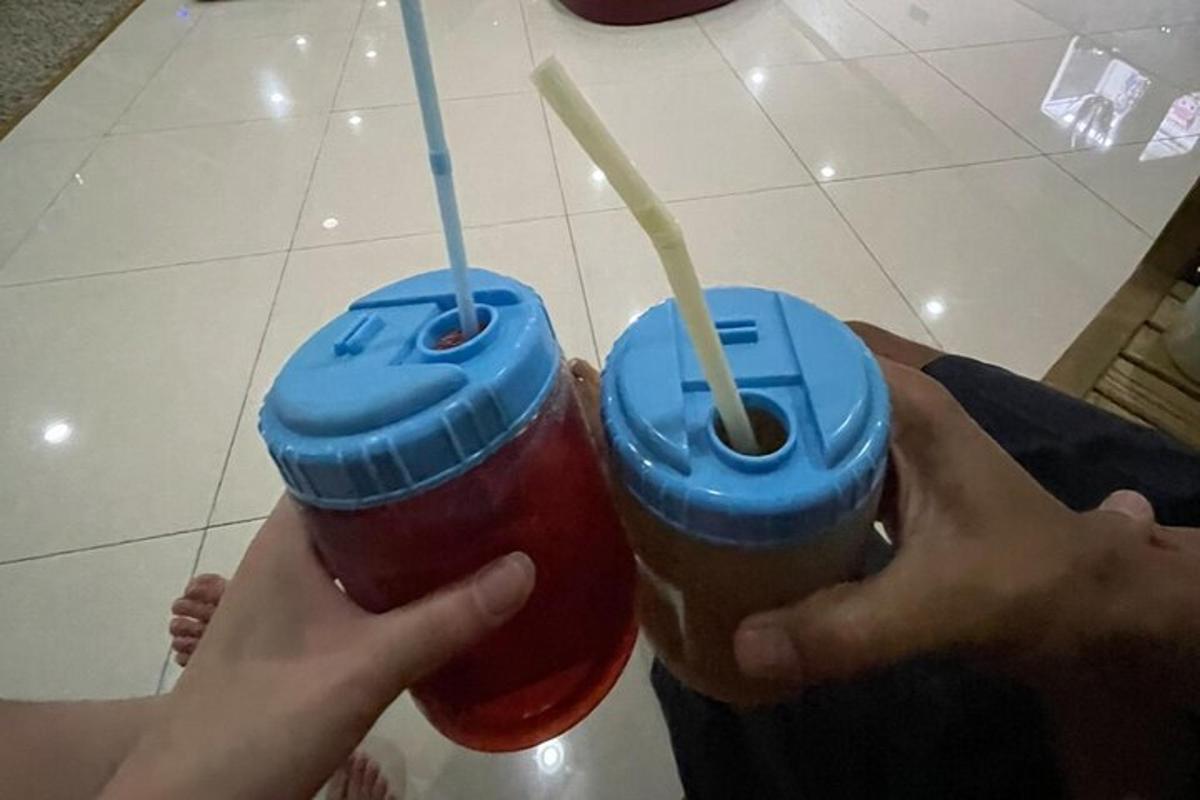 two people holding two drinks in their hands