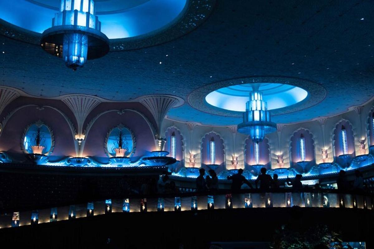 a large room with blue lighting and chandeliers