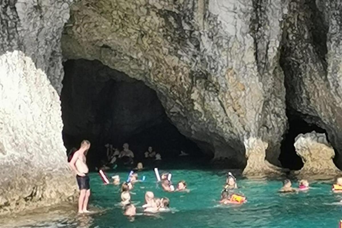 a group of people in the water in a cave