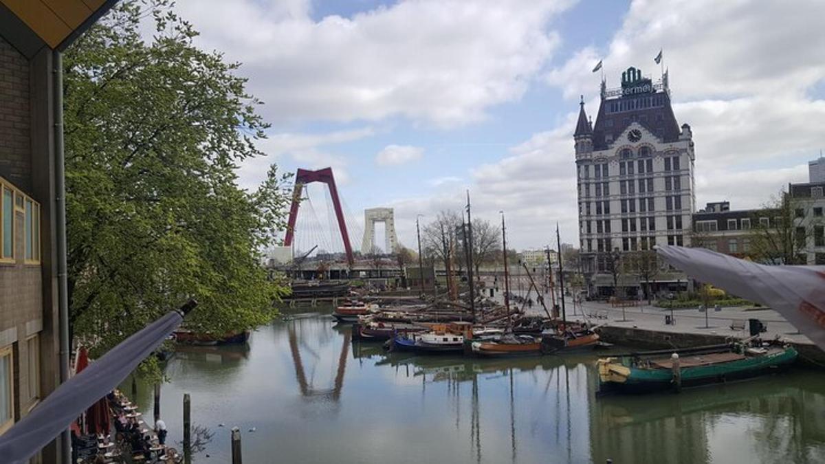 a river with boats in a city with a building