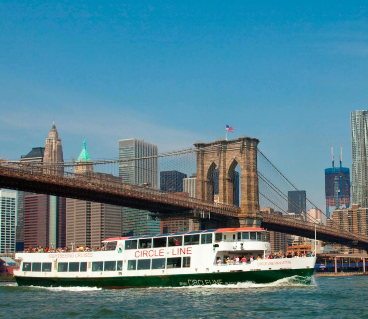 a cruise line boat passing under a bridge