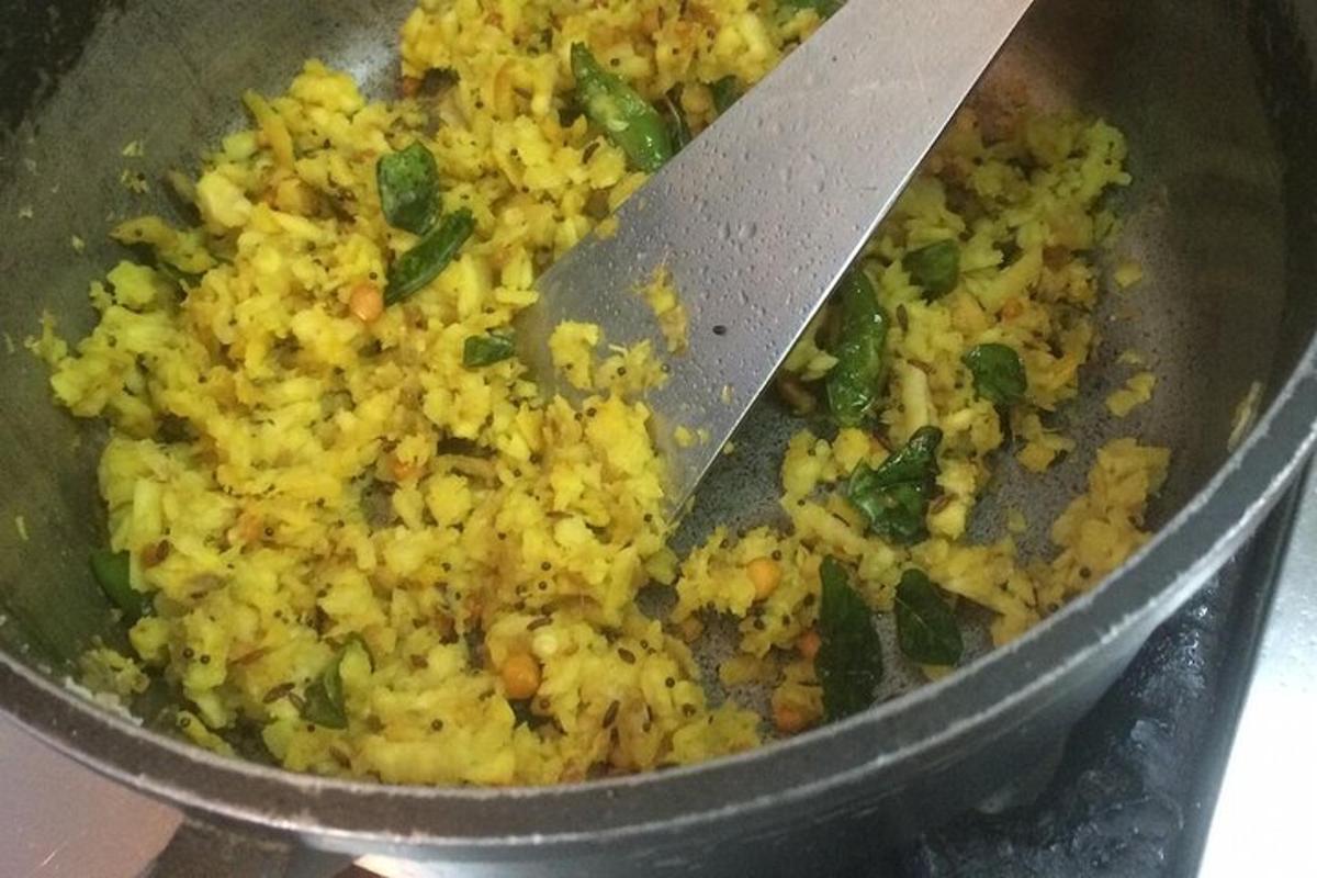 a pan of rice with a spatula in it