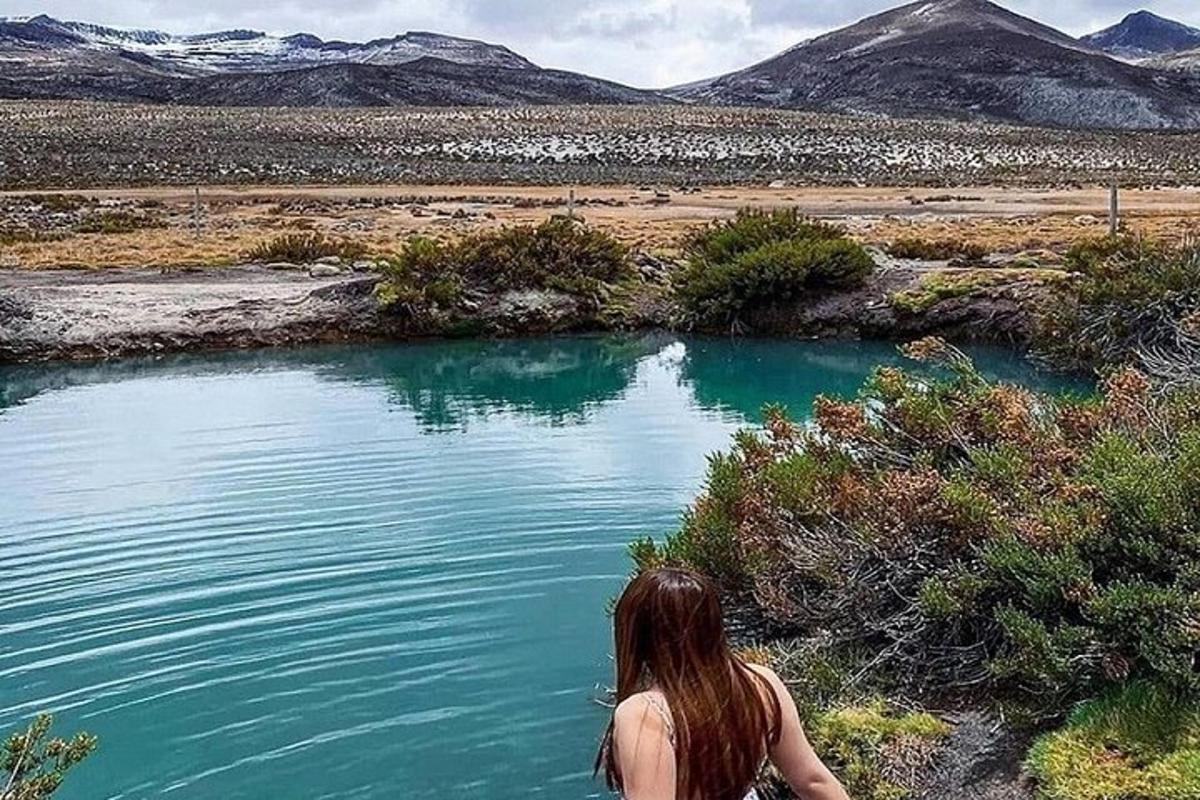 a woman standing next to a body of water