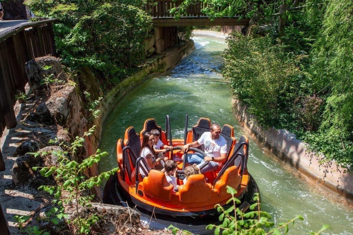 a group of people riding on a raft in a river