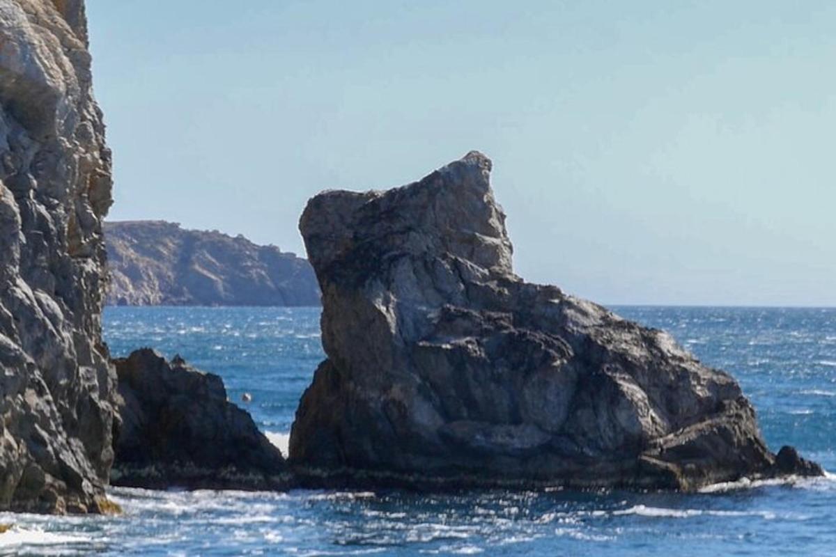 a large rock in the middle of the ocean
