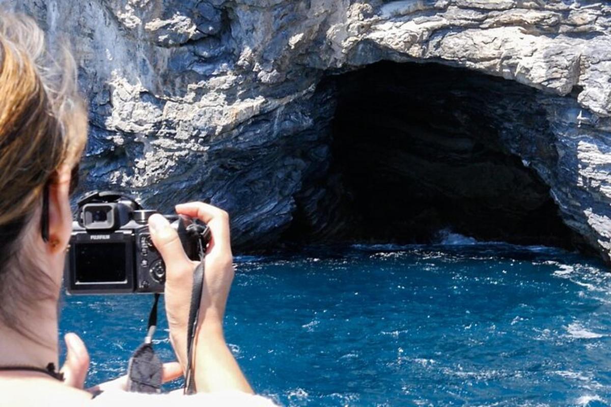 a woman taking a picture of a cave with a camera