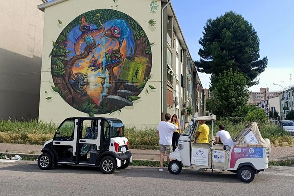 two golf carts parked in front of a building with a painting