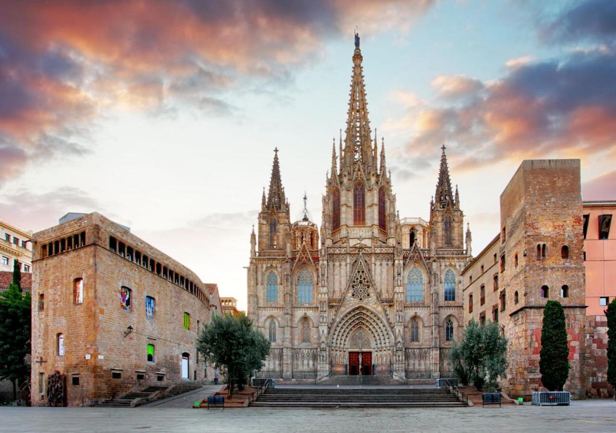 an old building with a cathedral with a cloudy sky