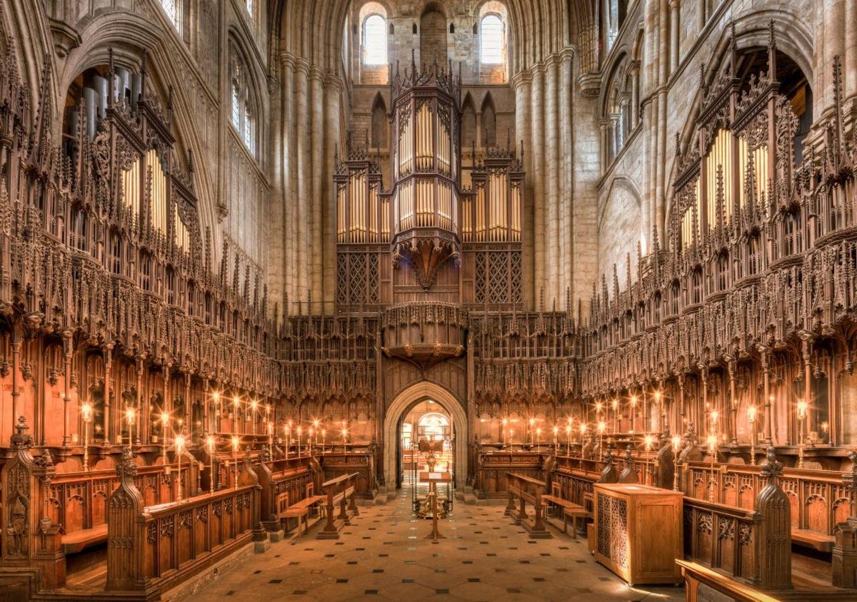 a large cathedral with wooden pews in it