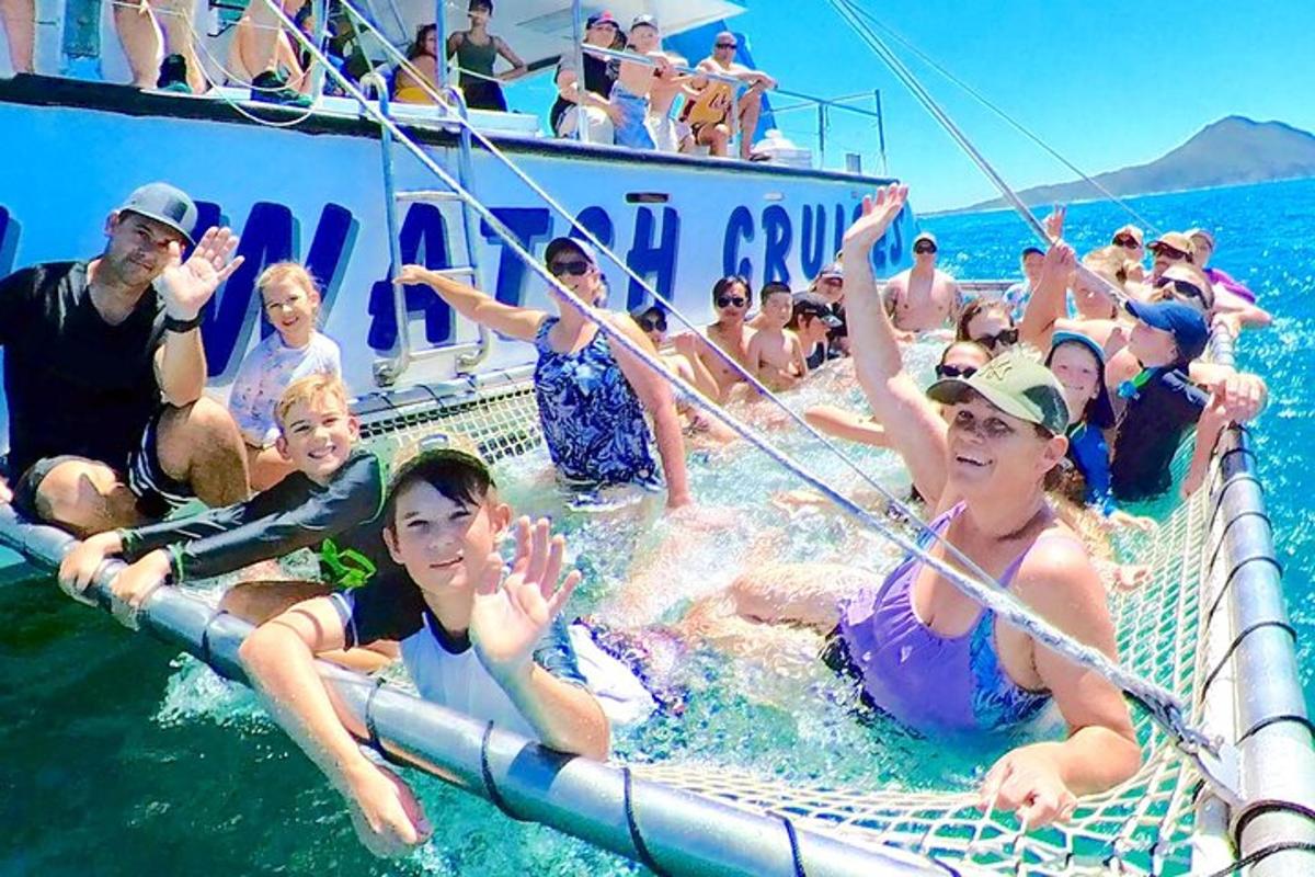 a group of people in the water on a boat