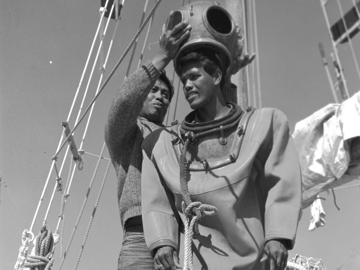 a man and a woman standing on a ship