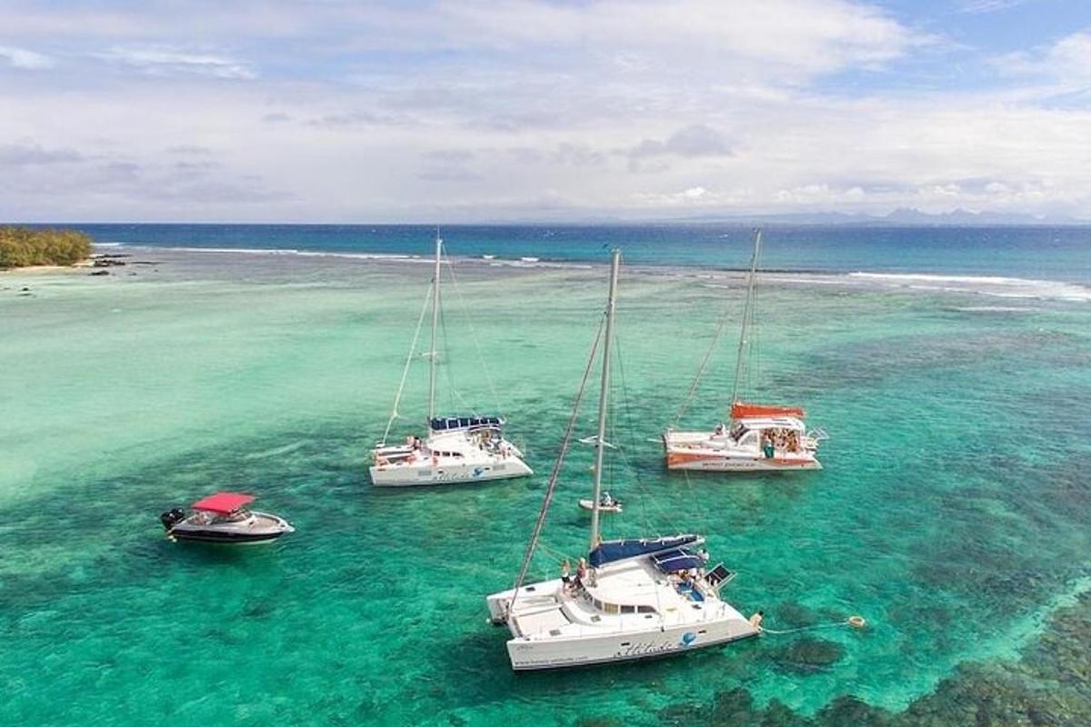 four boats sitting in the water in the ocean