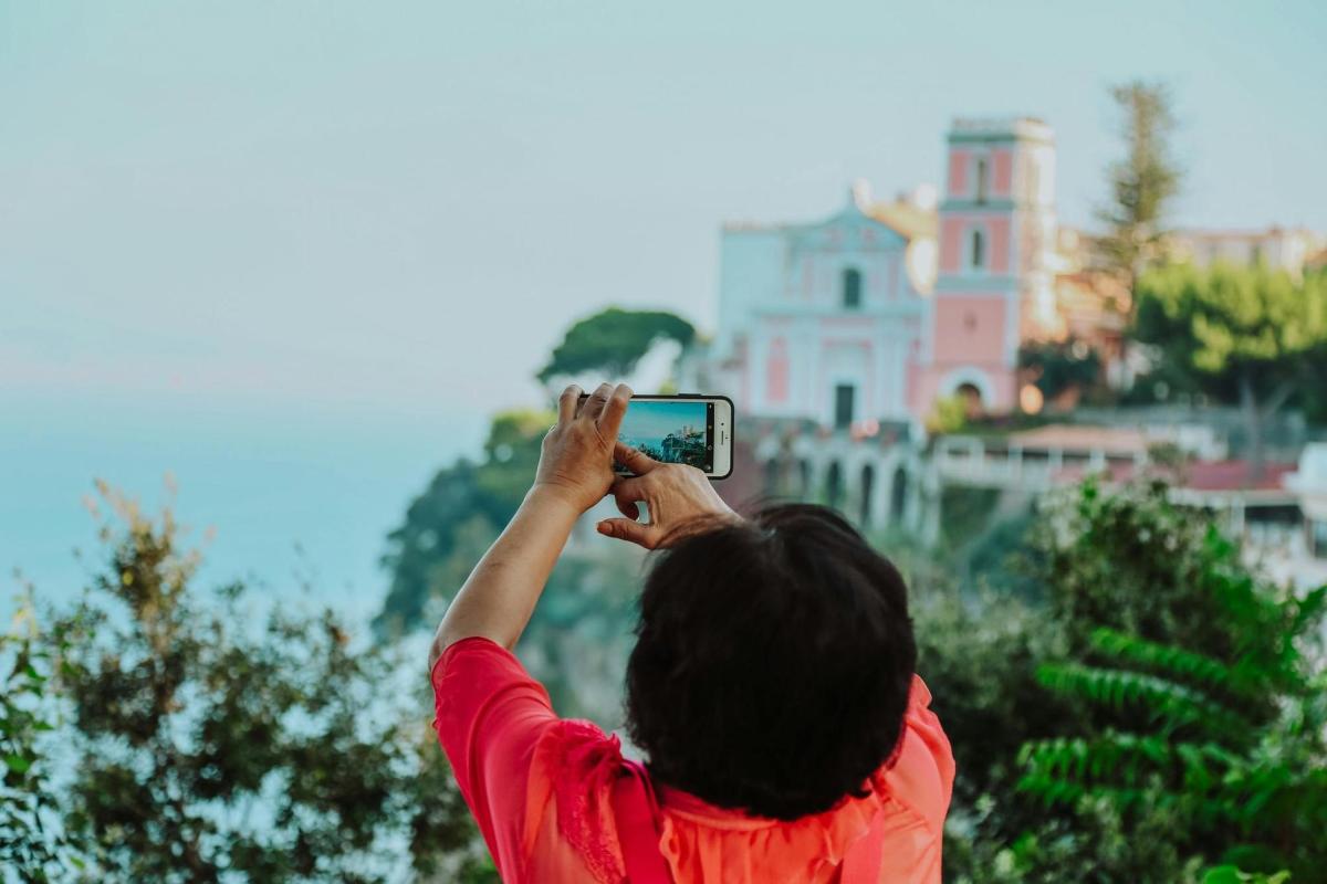 a person taking a picture of a building with a cell phone